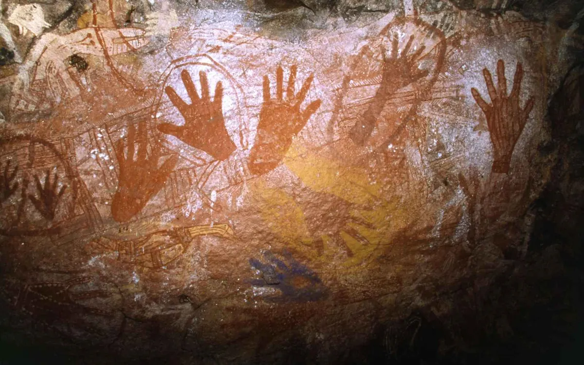 Ancient Aboriginal rock art on a sheltered rock wall at the base of Uluru
